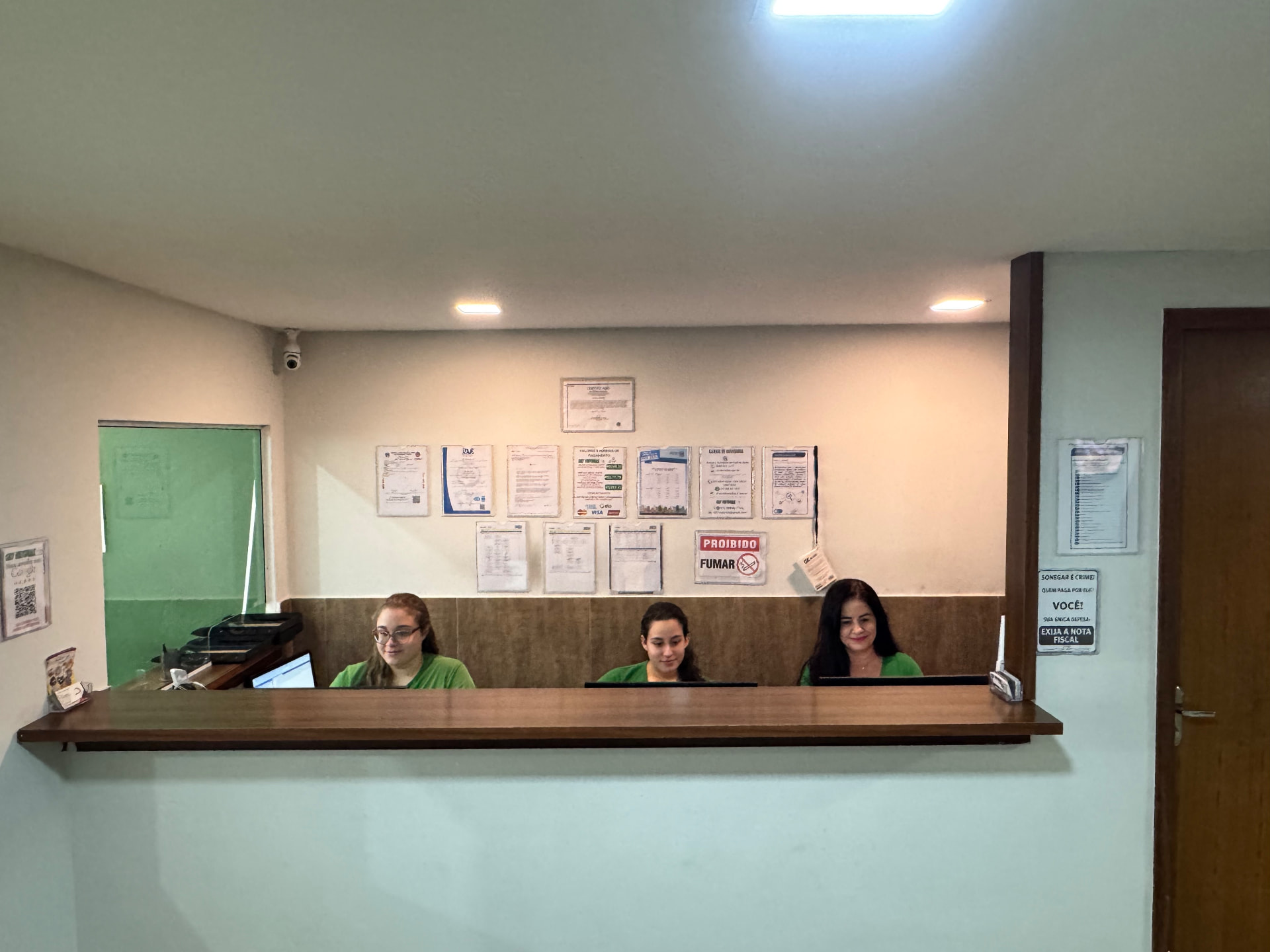 Equipe de atendimento da 027 Vistorias no balcão da recepção